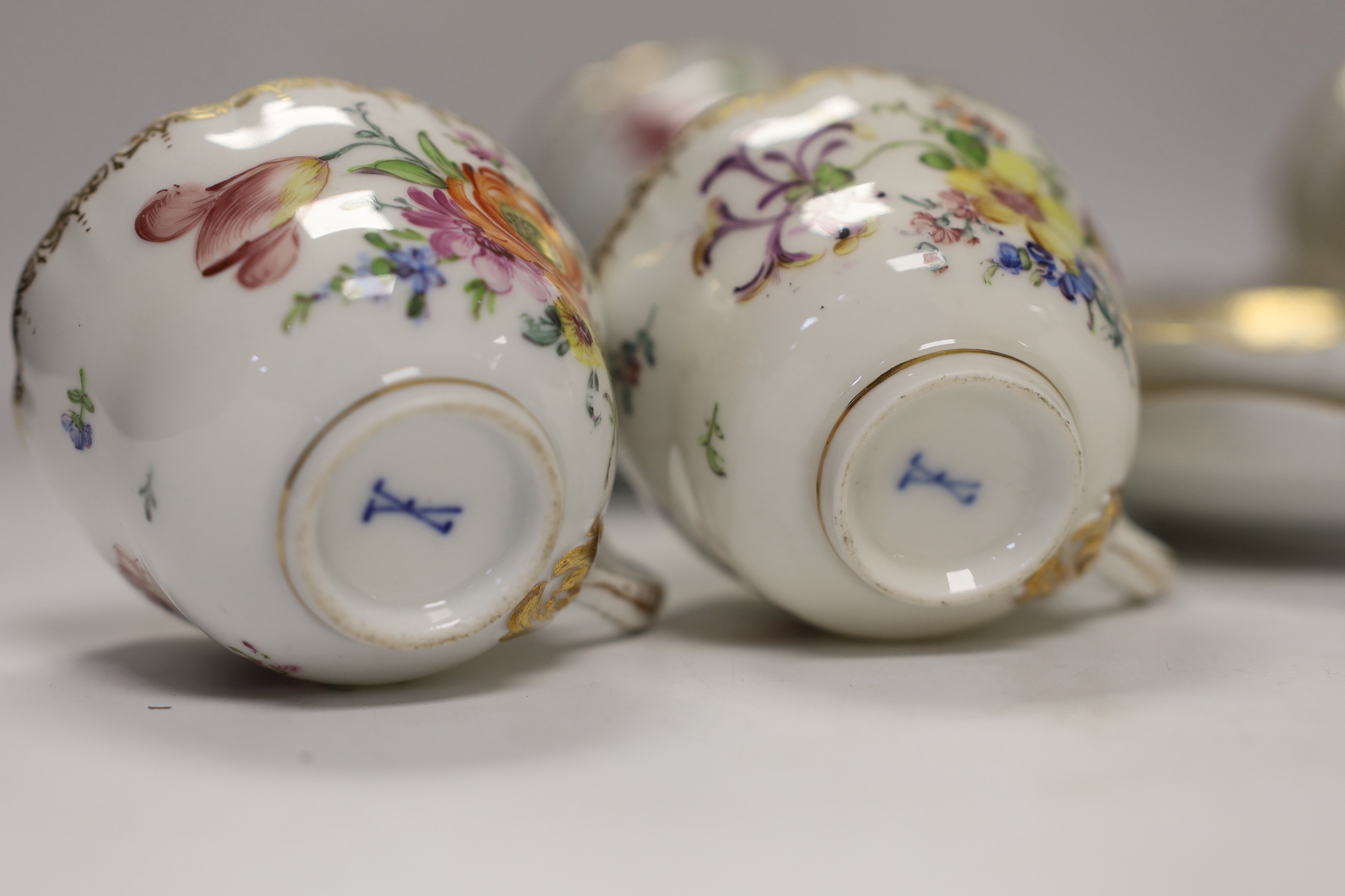 Twelve early 20th century Dresden floral tea cups and saucers